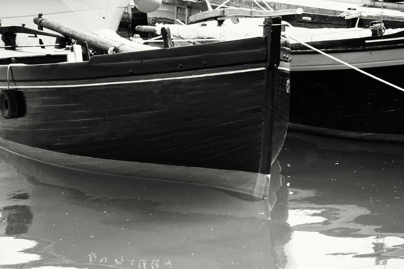 Dramatic black and white photo of a wooden boat prow