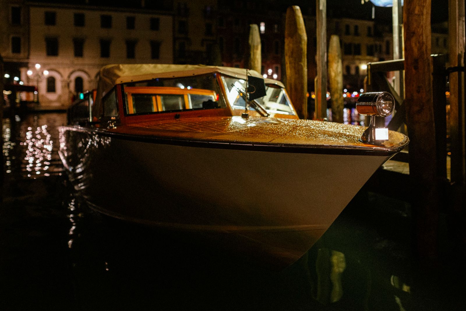 Restored mahogany runabout with brass fittings at night