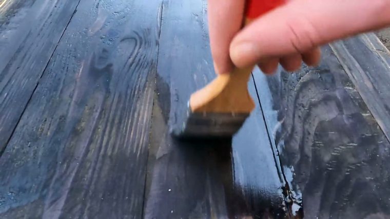 Hand-applied varnish coat on mahogany planking